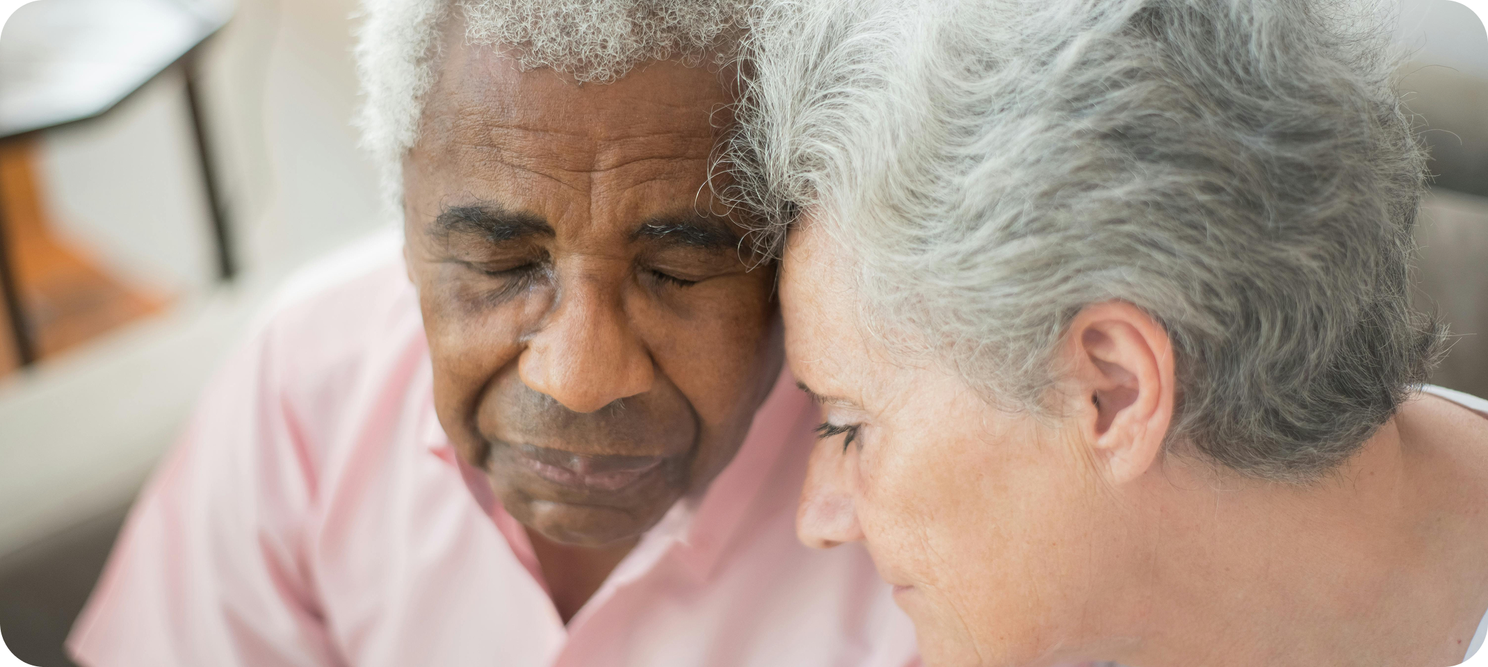Two people sitting together for comfort and support